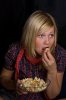 3050687-woman-eating-popcorn-and-watching-a-movie.jpg